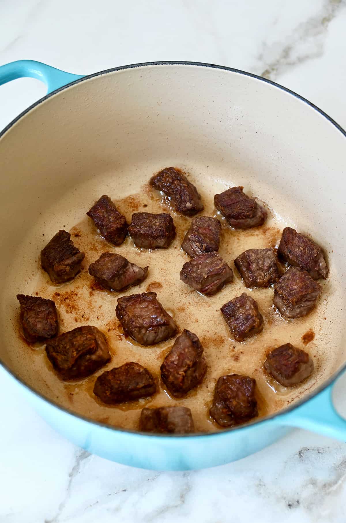 Browned beef in a dutch oven.