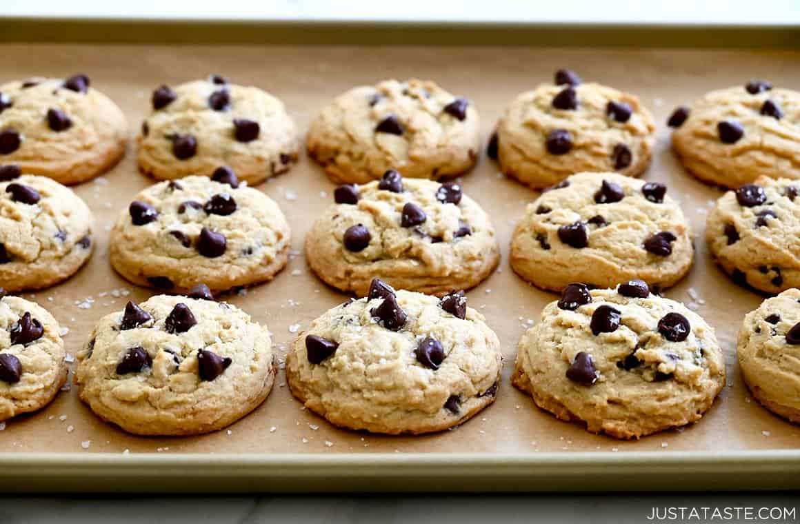 High Altitude Cookies topped with sea salt on a parchment paper-lined baking sheet