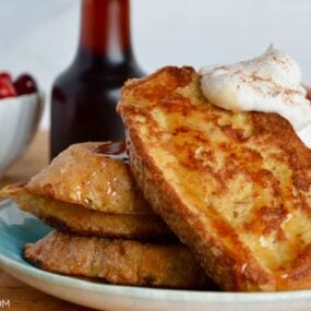 Homemade Eggnog French Toast topped with whipped cream