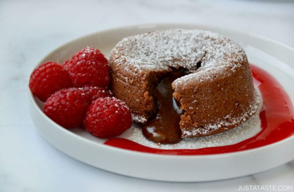 The best Chocolate Lava Cake with Raspberry Sauce, powdered sugar and fresh raspberries