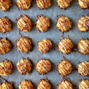 A top-down view of coconut macaroons drizzled with milk chocolate