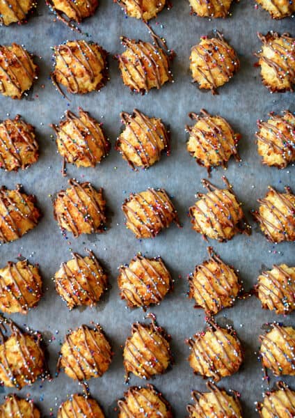 A top-down view of coconut macaroons drizzled with milk chocolate