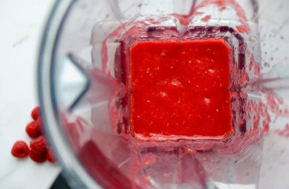 Blender containing fresh raspberry sauce