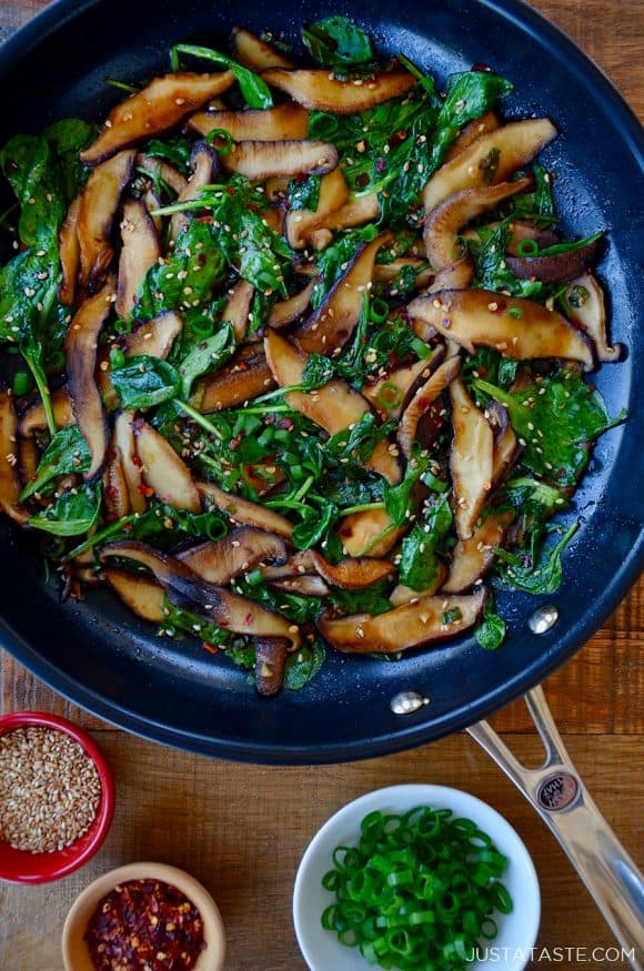 Skillet with sauteed mushrooms and spinach in a spicy garlic sauce