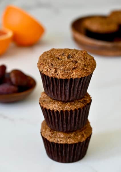 Healthy bran muffins with orange zest stacked three high.