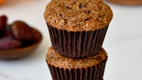 Healthy bran muffins with orange zest stacked three high.