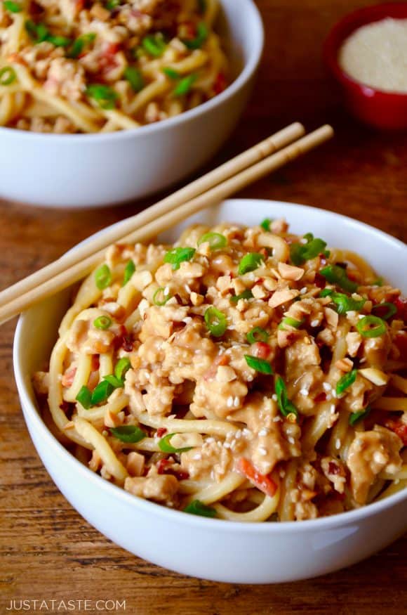 White bowl with chopsticks containing Dan Dan Noodles with Chicken