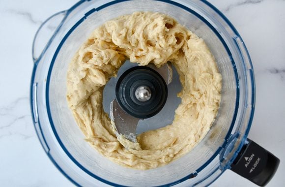 A food processor containing blended banana nice cream