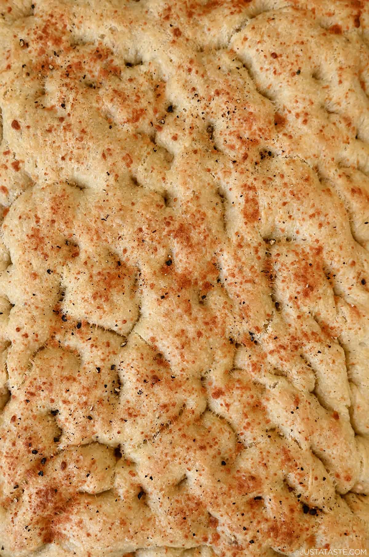Homemade focaccia with black pepper and grated cheese.