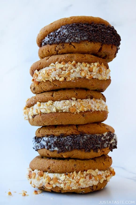 A stack of cookies sandwiches rolled in crushed peanuts and chocolate sprinkles
