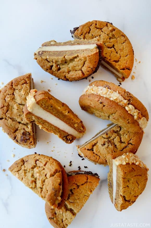 A top-down view of halved ice cream sandwiches on a white marble background