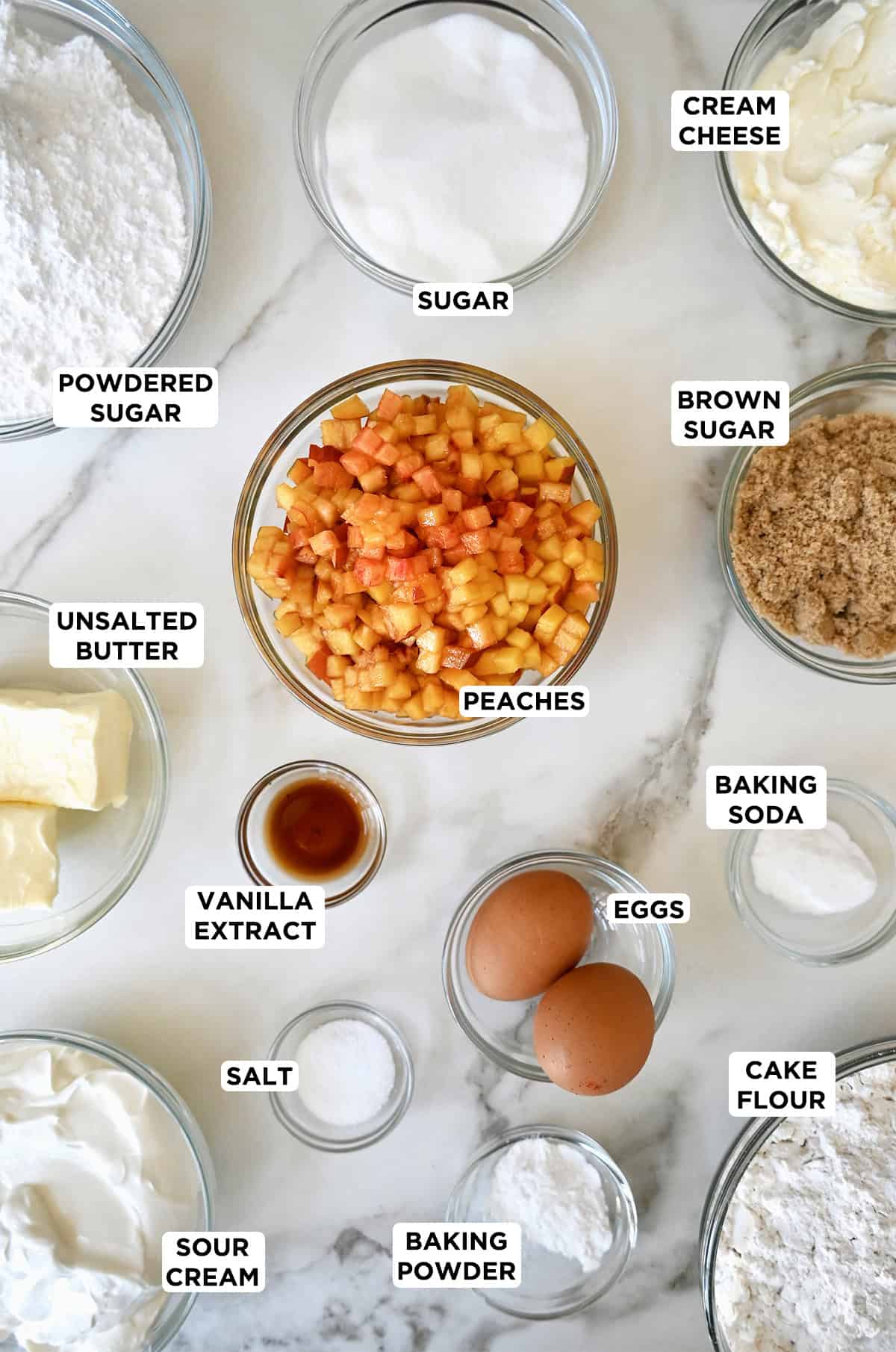 All the ingredients needed to make homemade peach cupcakes from scratch with fresh peaches.