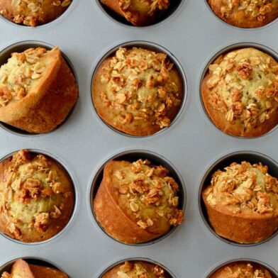 Muffin pan containing freshly baked Banana Granola Muffins