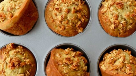 Muffin pan containing freshly baked Banana Granola Muffins