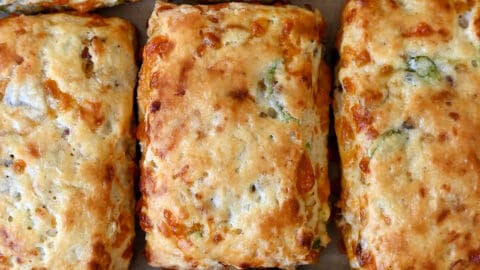 Golden brown bacon-cheddar biscuits with scallions.
