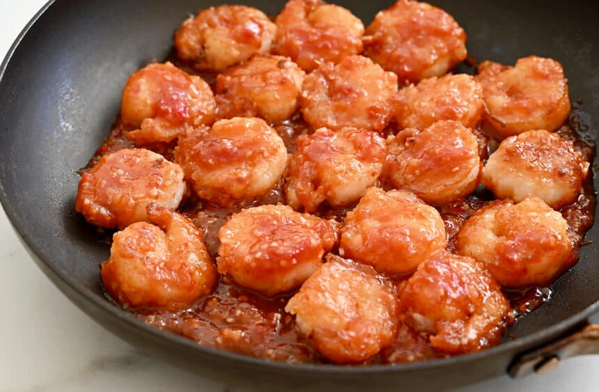 Sticky sweet and sour shrimp in a single layer in a nonstick skillet