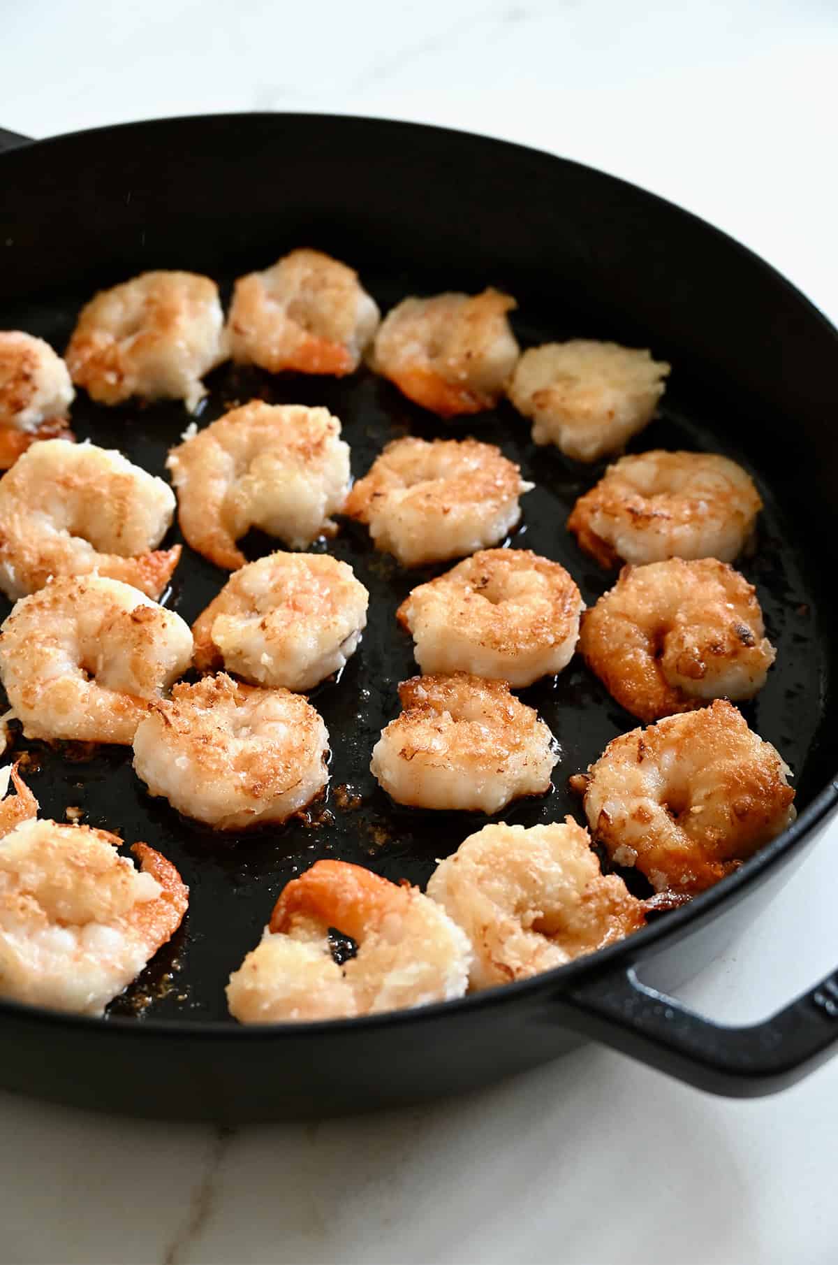 Crispy shrimp in a skillet.