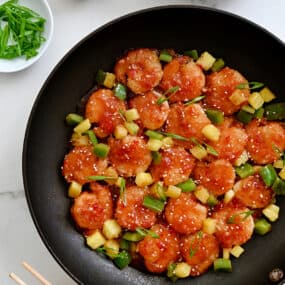 Sweet and Sour Shrimp in a large nonstick skillet with pineapple chunks and sliced green pepper