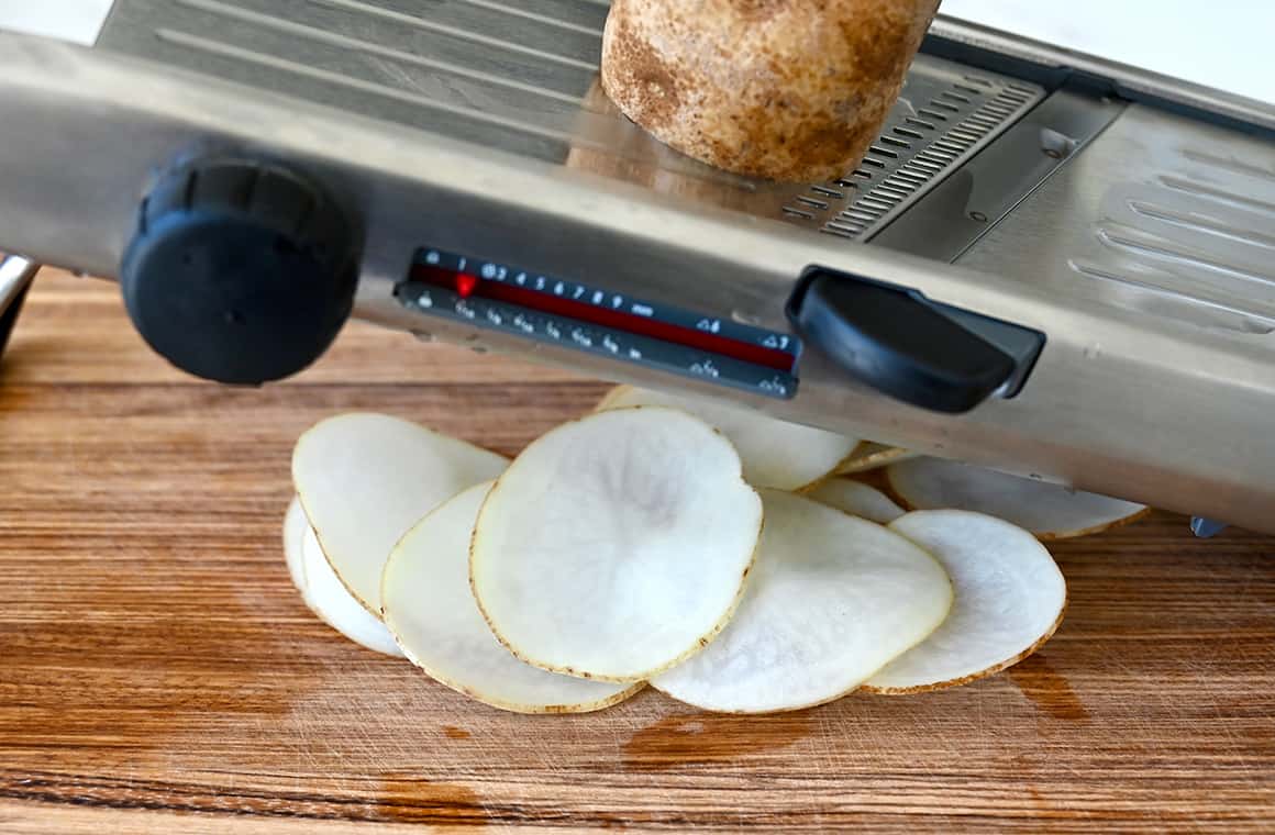 A mandolin creates thin slices of potato