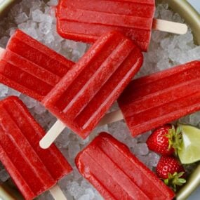 Top down view of Strawberry Margarita Popsicles on ice