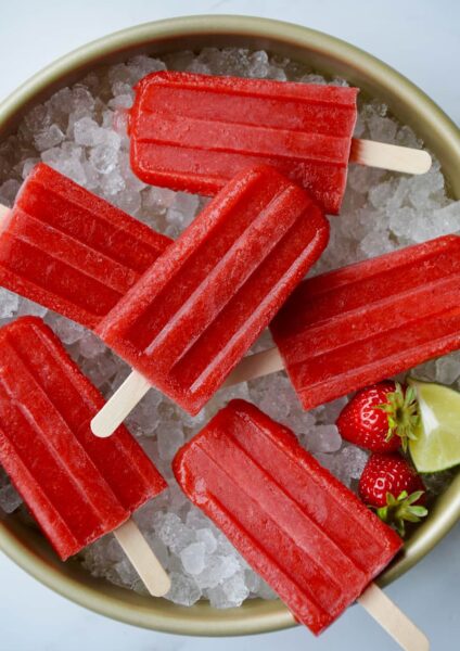 Top down view of Strawberry Margarita Popsicles on ice