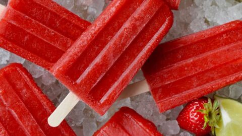 Top down view of Strawberry Margarita Popsicles on ice