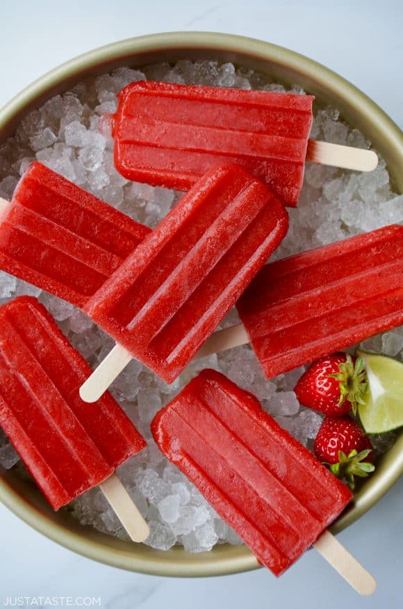 Top down view of Strawberry Margarita Popsicles on ice