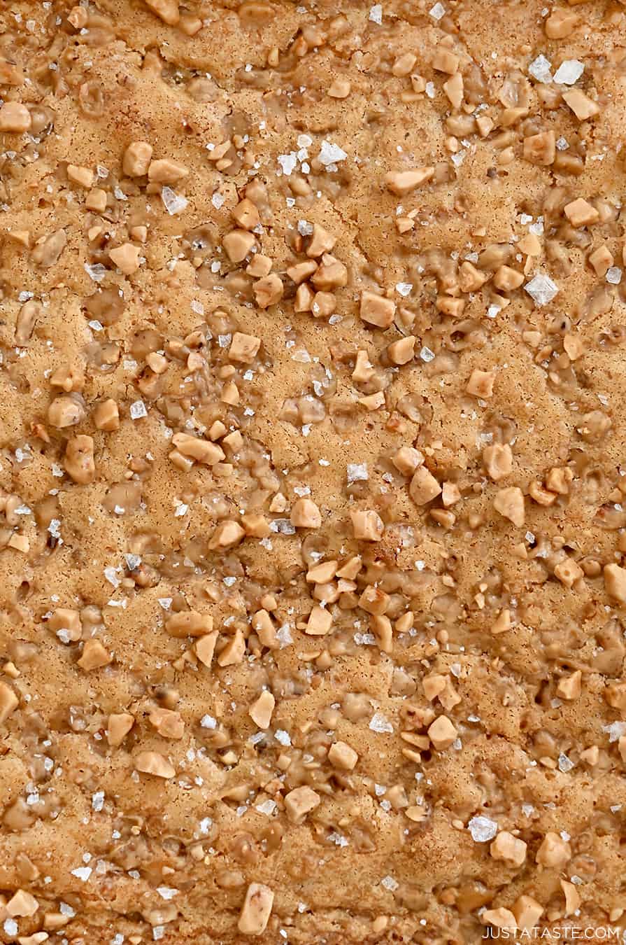 A closeup view of blondies topped with toffee bits and large-flake sea salt.