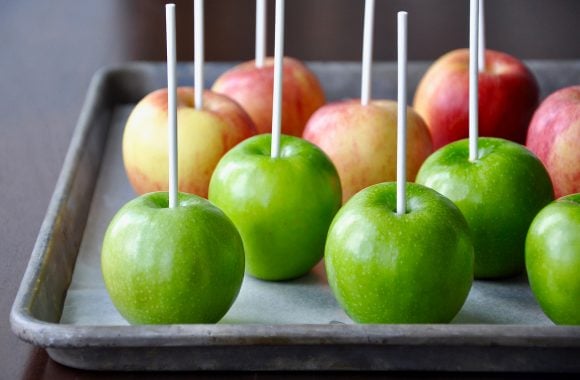 Green and red apples with white sticks for candy apples