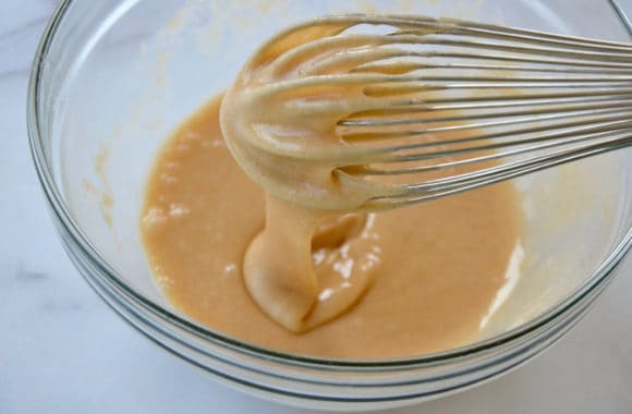 Whisk in bowl containing cookie batter