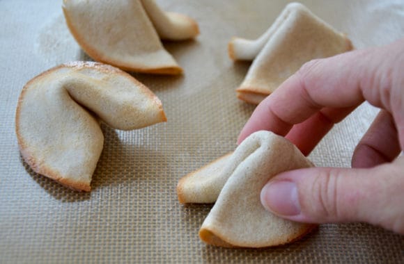 Hand shaping fortune cookies