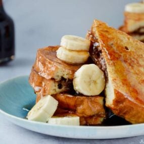 Easy Banana and Nutella Stuffed French Toast topped with banana slices