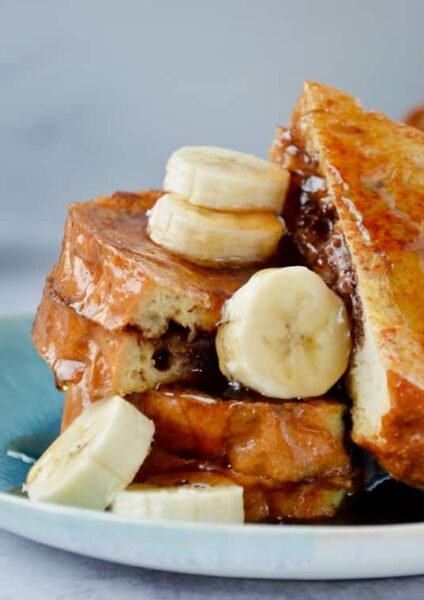 Easy Banana and Nutella Stuffed French Toast topped with banana slices