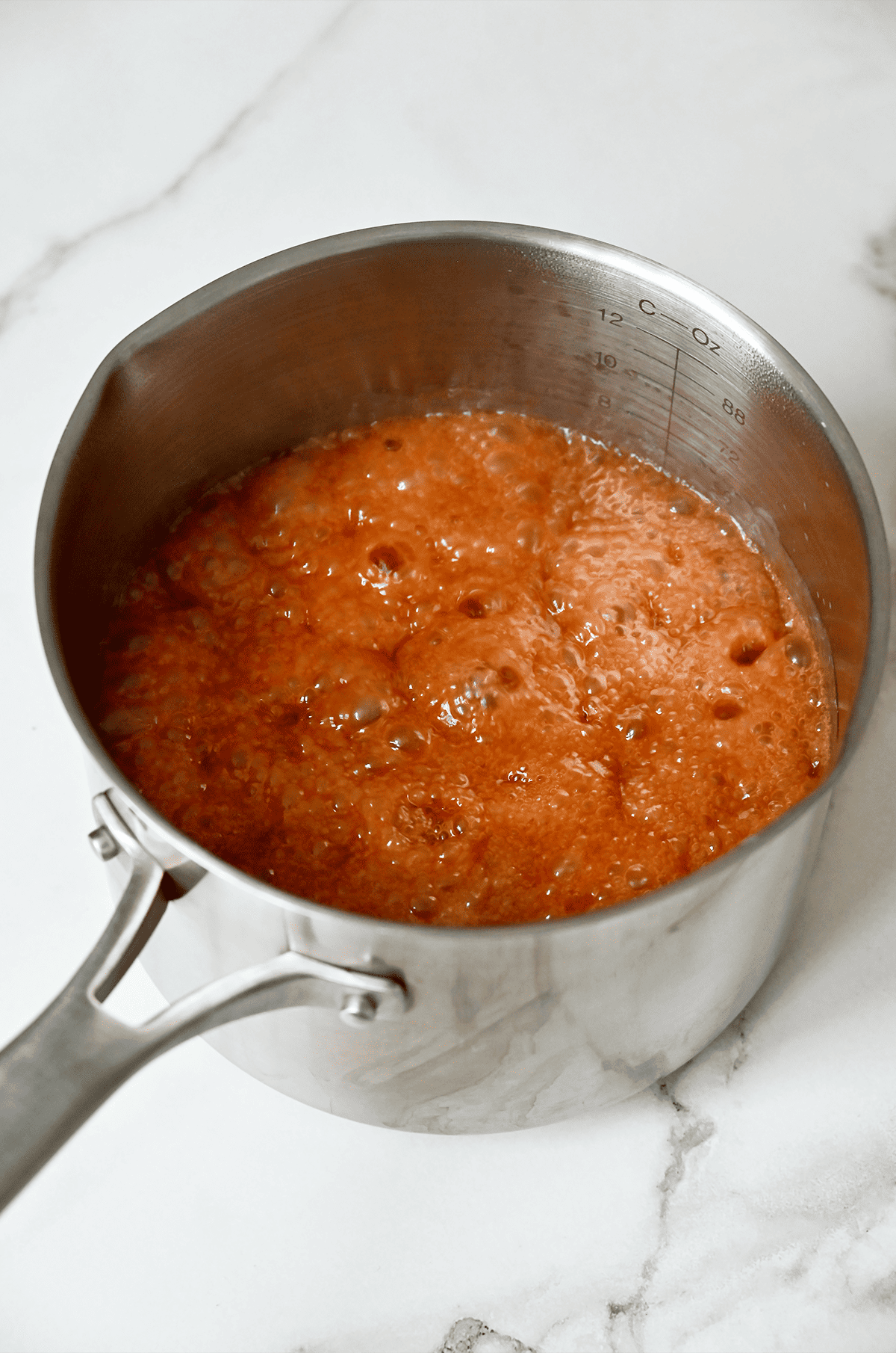 Caramel gently bubbling in a saucepan.