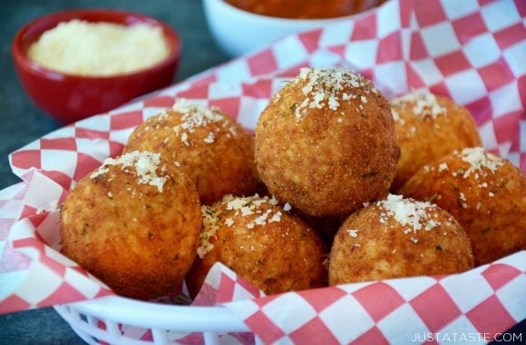 Easy arancini in basket topped with parmesan cheese