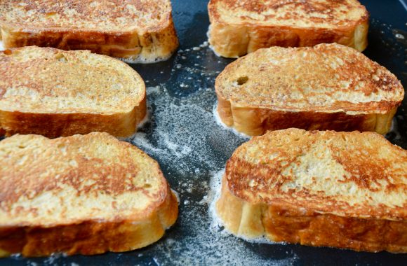 Frying stuffed French toast in large skillet containing butter