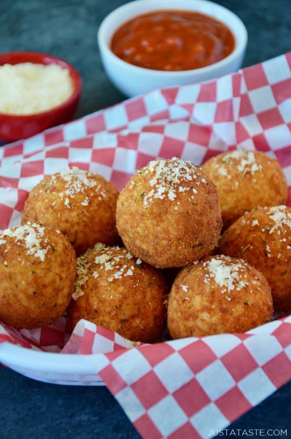 The best arancini rice balls in a basket sprinkled with parmesan cheese