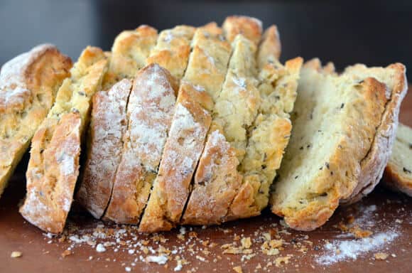 Slices of homemade Irish soda bread sit on a cutting board.