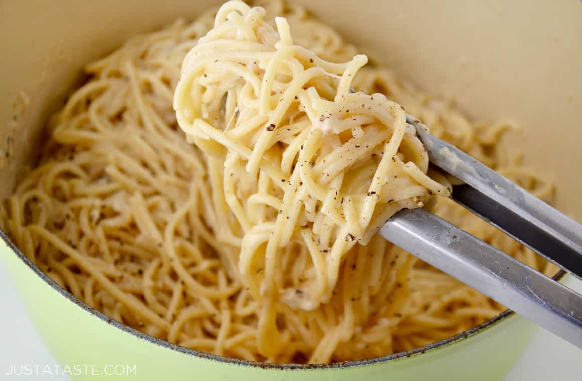 Large pot containing Cacio e Pepe Pasta and tongs