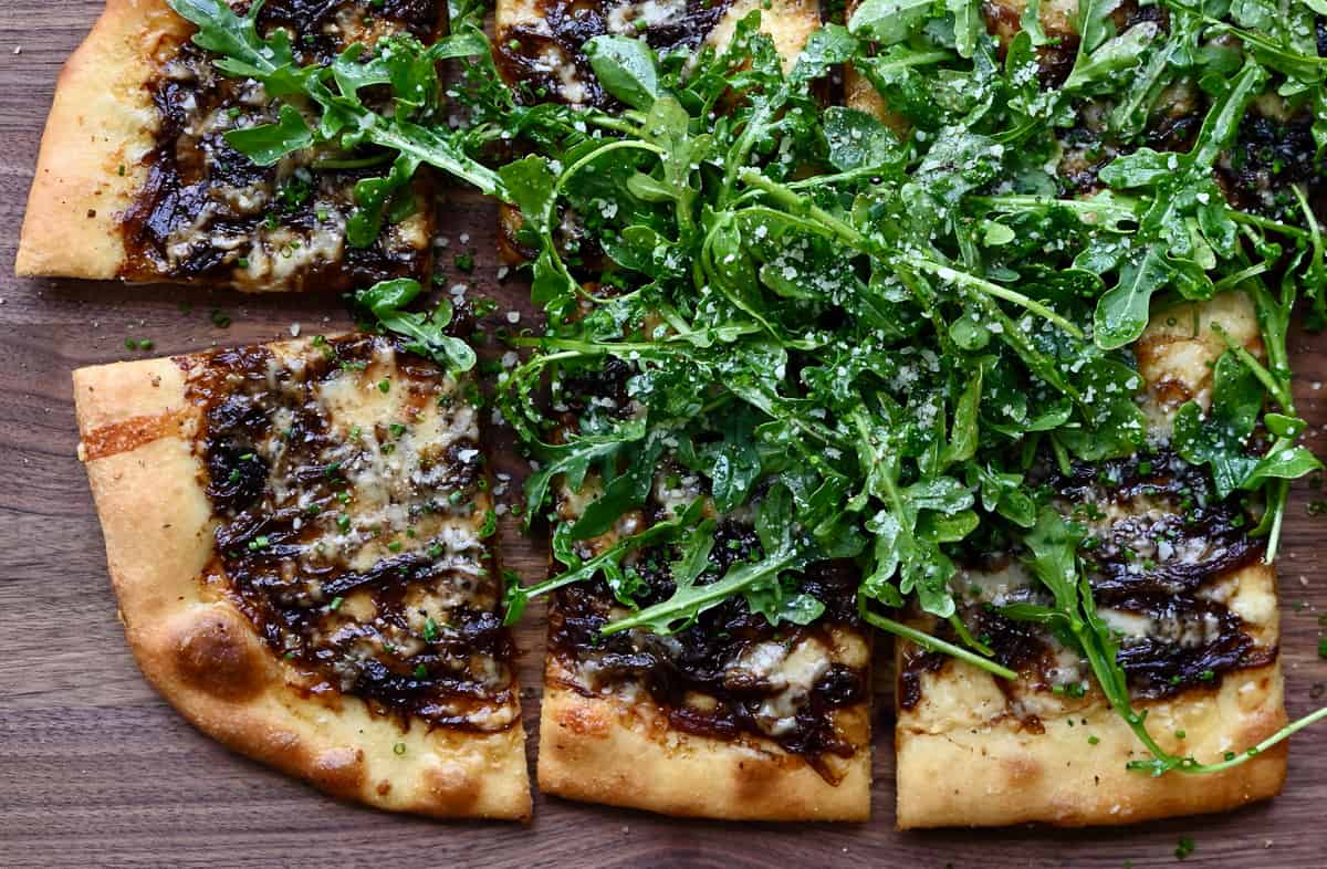 Caramelized balsamic onion and gruyere pizza topped with arugula. 