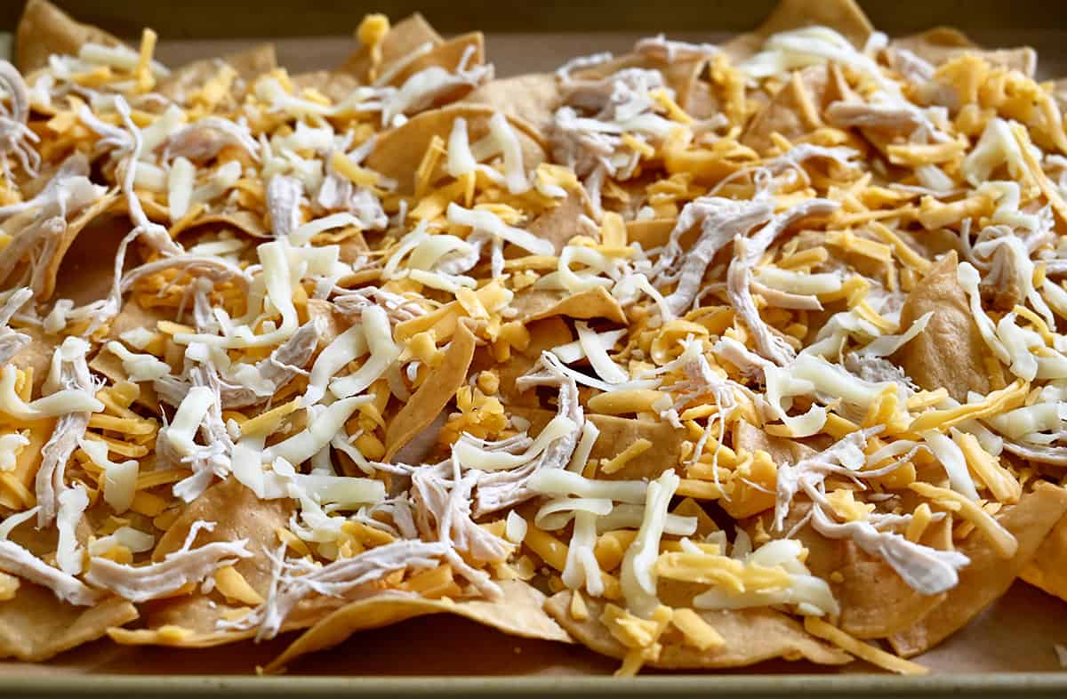 Tortilla chips topped with shredded cheddar and Monterrey jack cheeses, and shredded rotisserie chicken.
