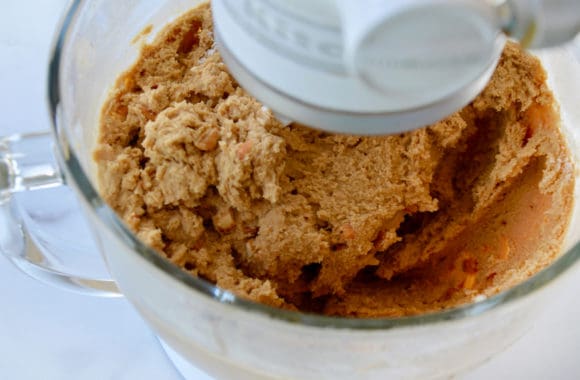 Glass stand mixer bowl containing cookie dough