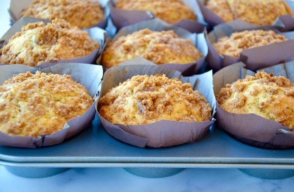 Muffins topped with streusel in paper-lined muffin tin