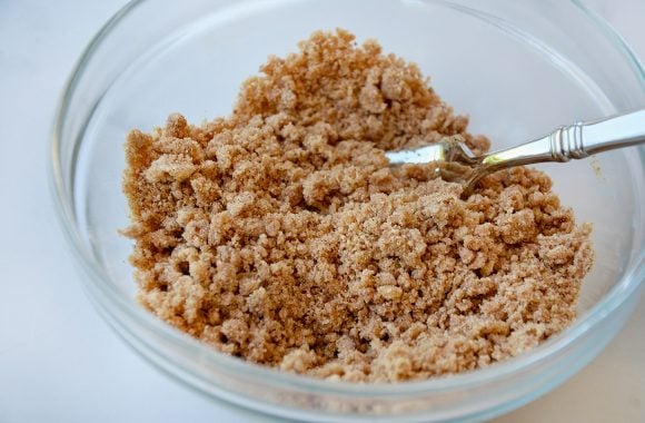 Fork in bowl containing streusel crumble
