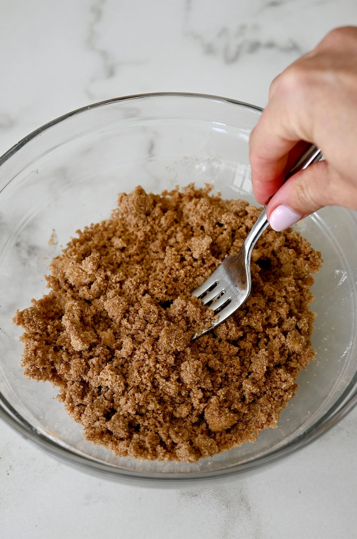 Cinnamon streusel topping in a bowl with a fork.