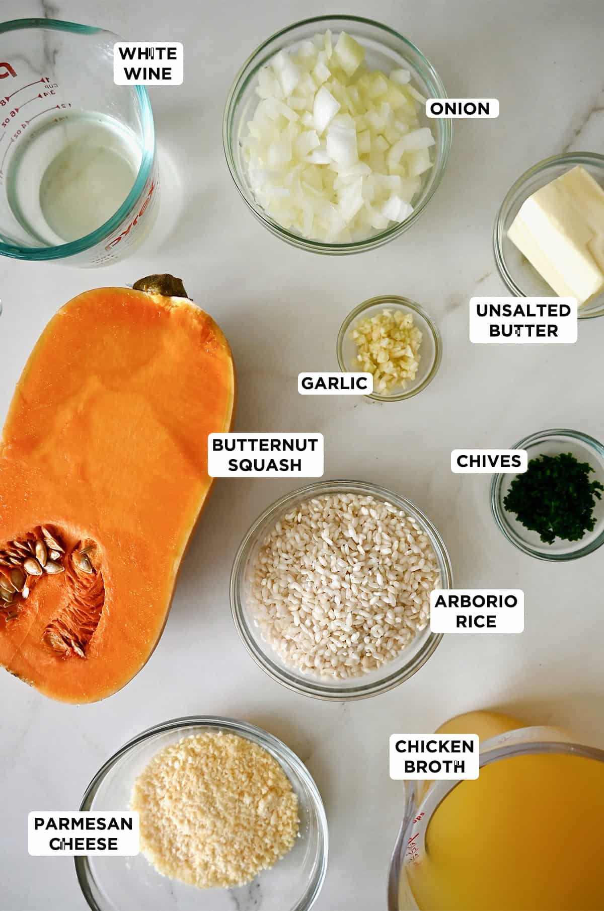 Ingredients to make butternut squash risotto in various sizes of glass bowls.