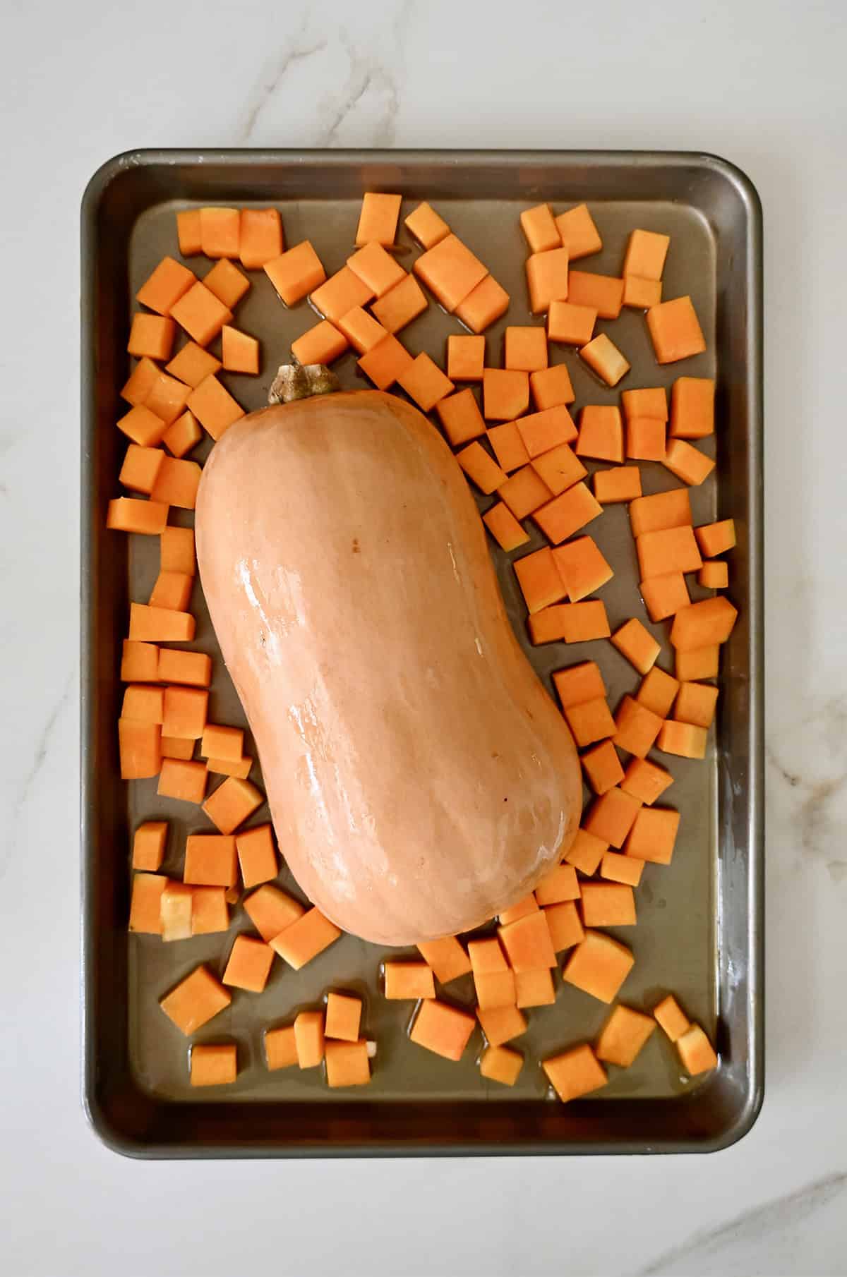 Roasting butternut squash two ways on a baking sheet.