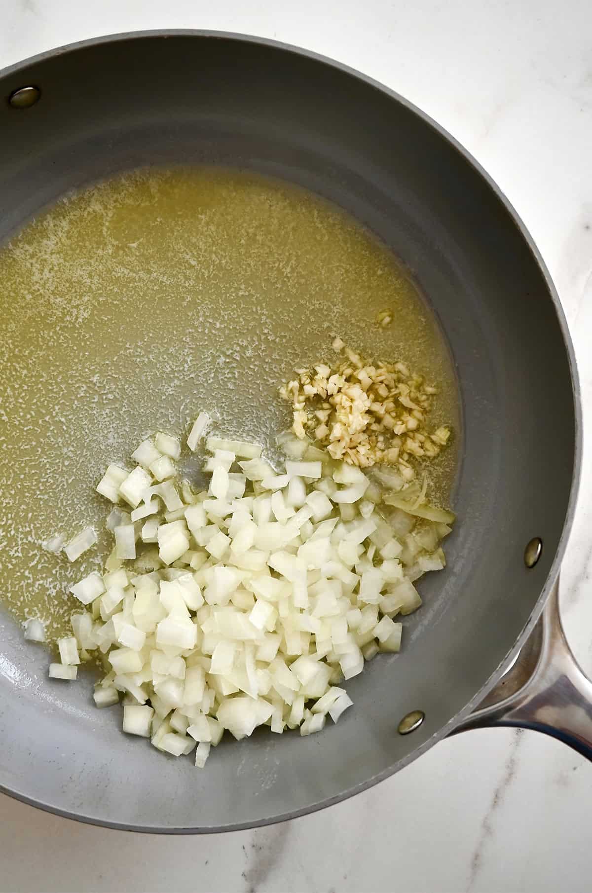 Sautéed onions and garlic in butter in a large saucepan.