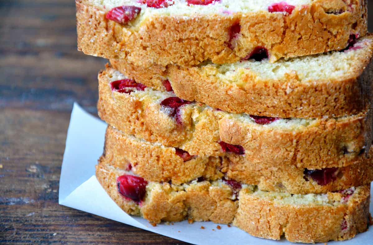 Sliced of cranberry orange bread stacked six high.