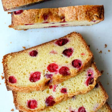 A loaf of cranberry orange bread cut into slices.